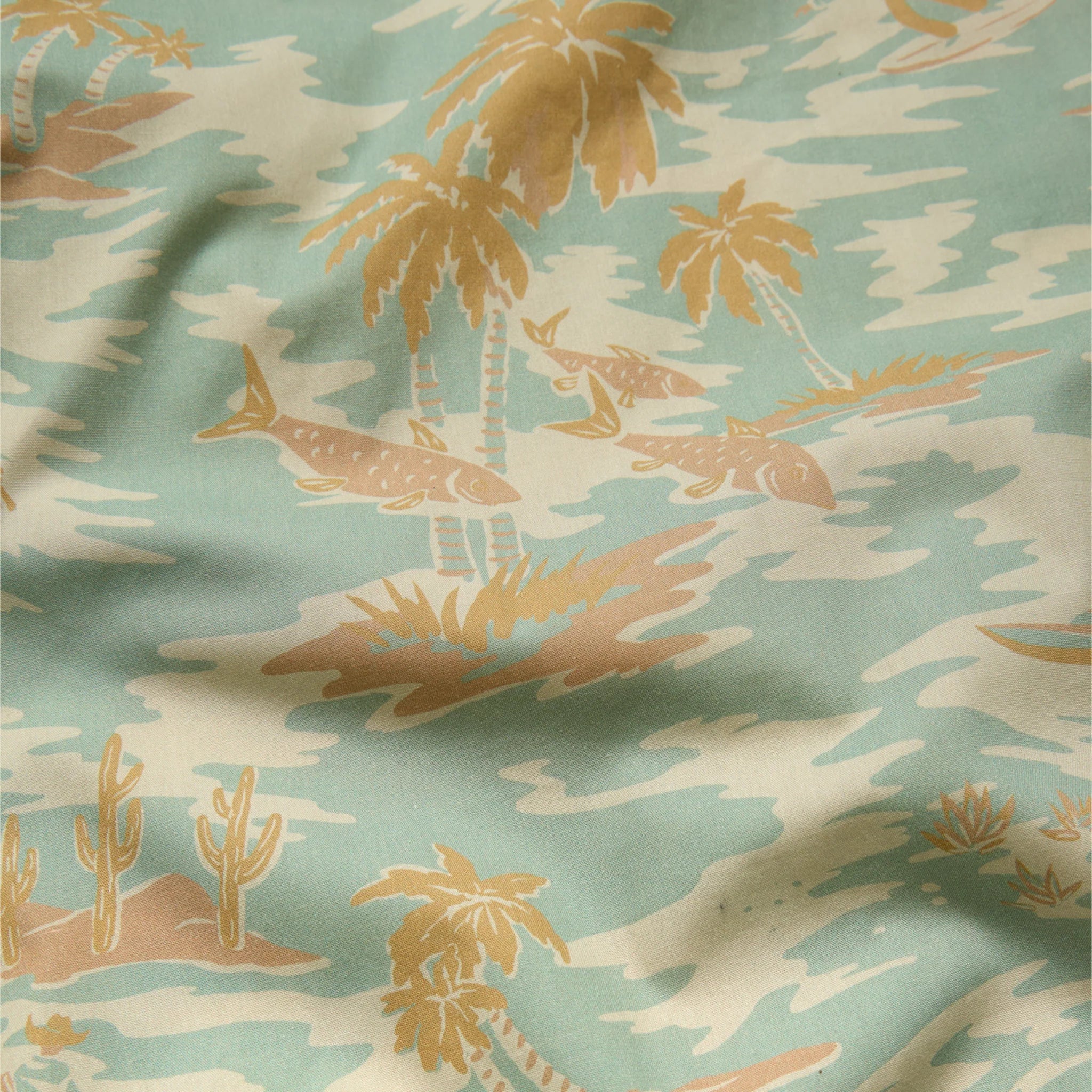 Fabric with a desert-themed pattern featuring palm trees, cacti, and landscapes.