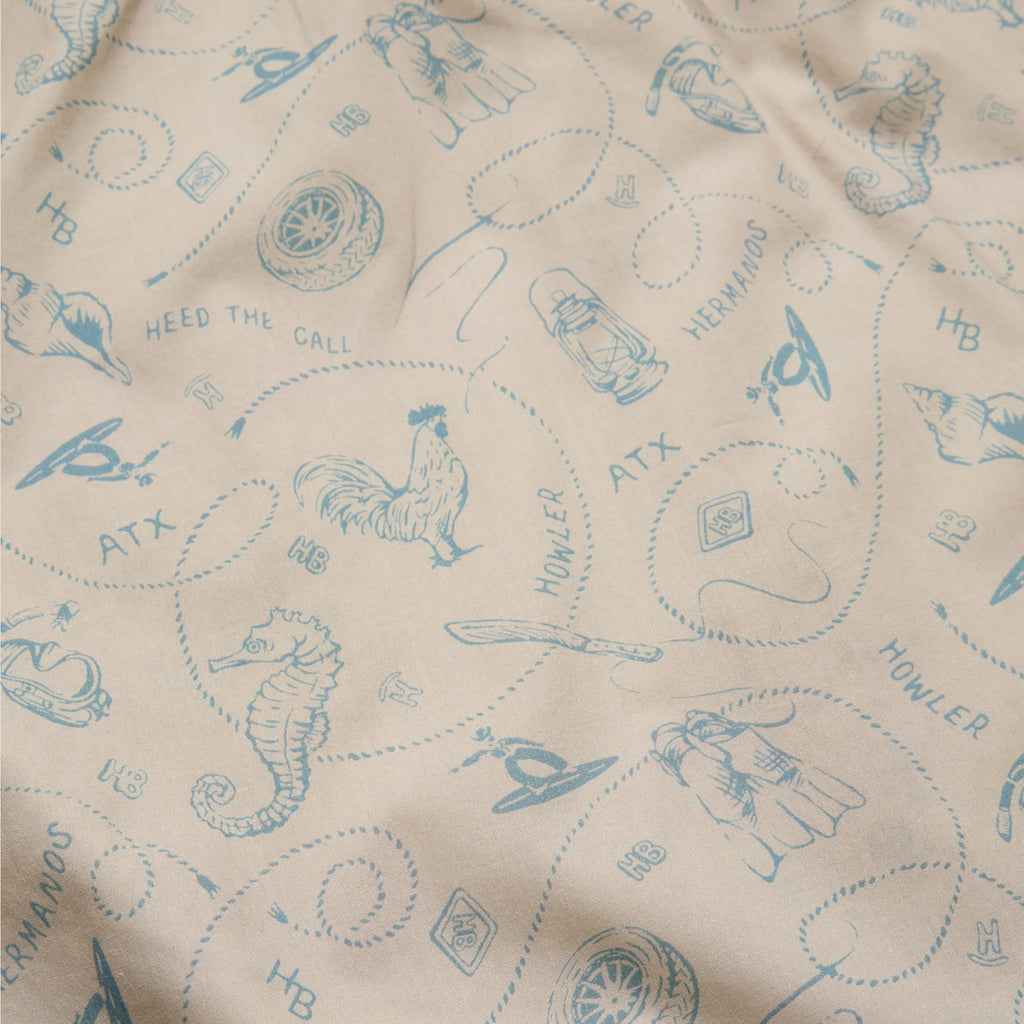 Beige fabric with blue embroidered patterns and text
