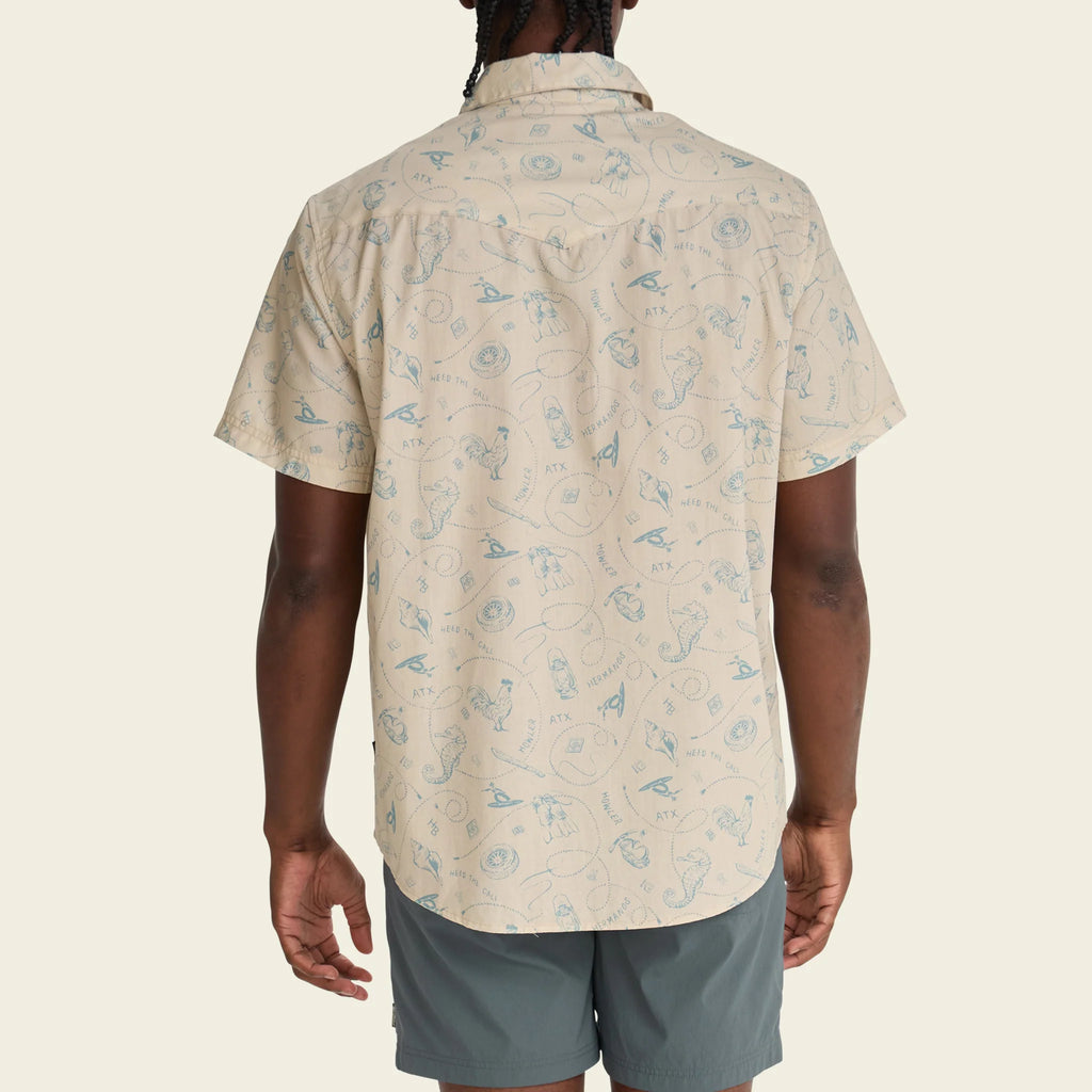 Person wearing a beige patterned shirt and gray shorts on a white background