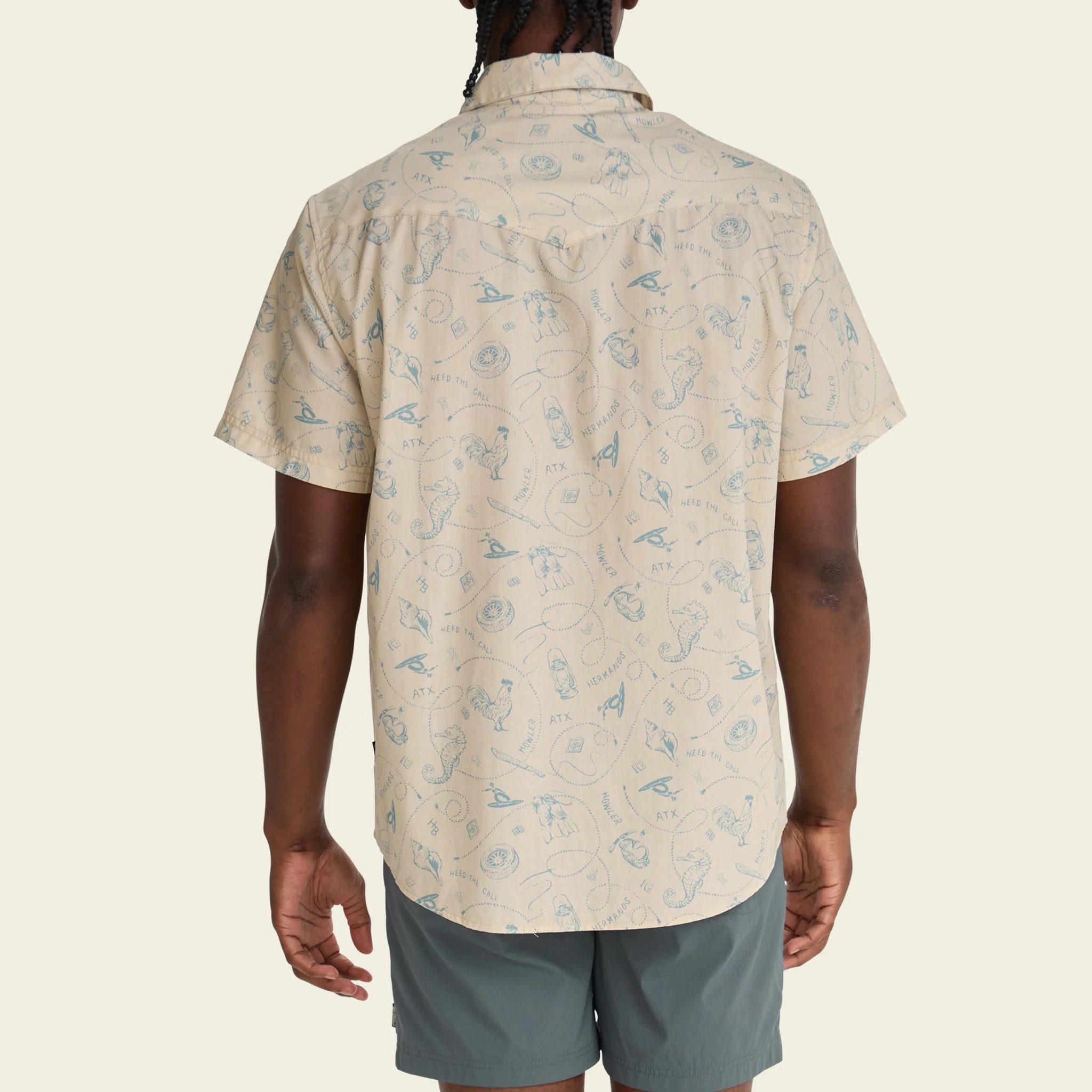 Person wearing a beige patterned shirt and gray shorts on a white background