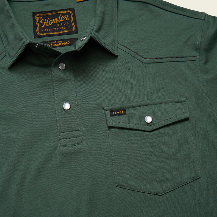Green shirt with a brand label on the collar and pocket.