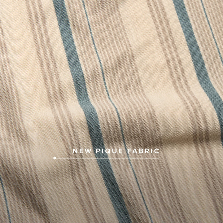Textured fabric with blue and beige stripes and 'New Pique Fabric' label.