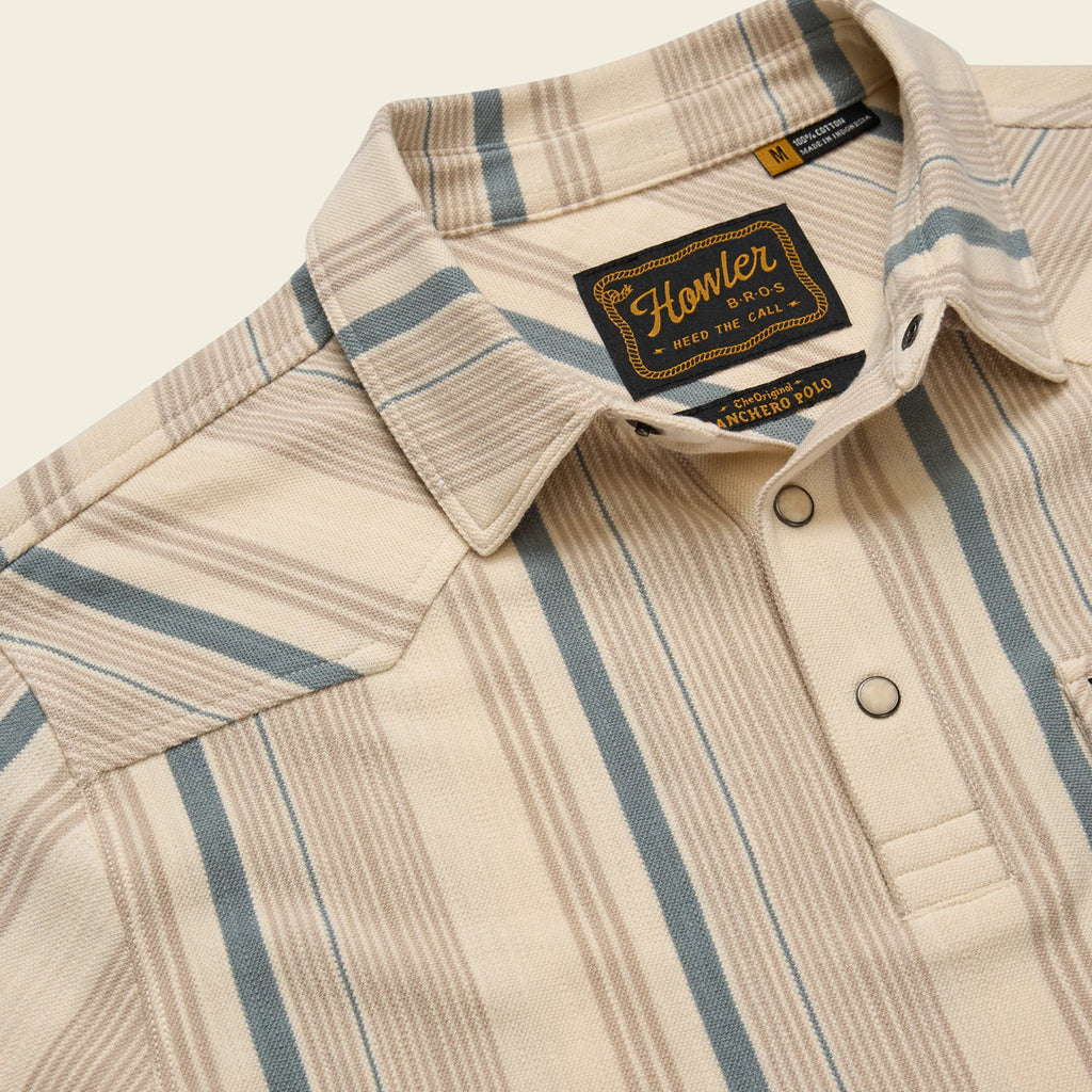 Beige and blue striped shirt with a brand label on a beige background