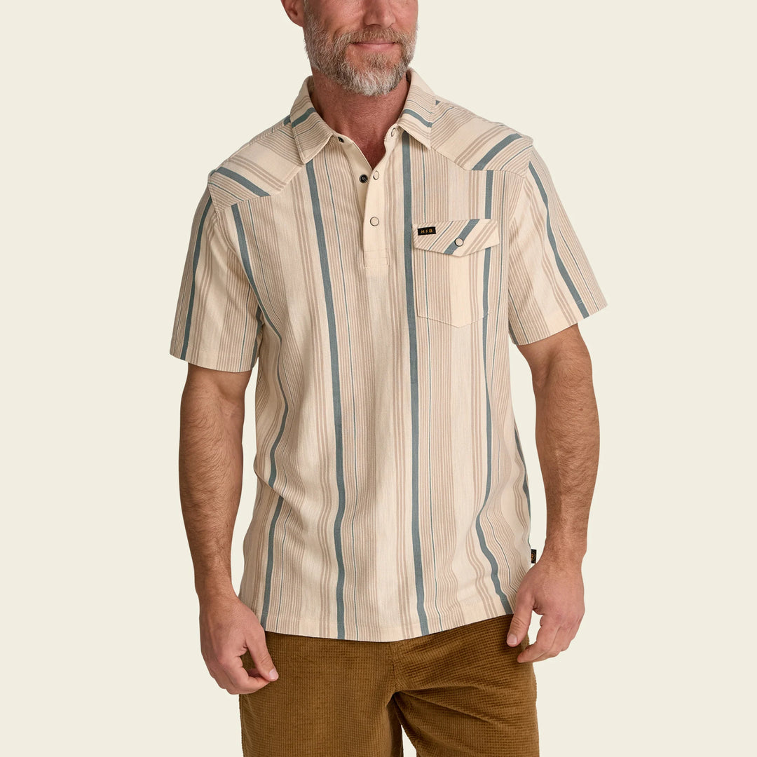 Man wearing a beige and blue striped shirt on a beige background