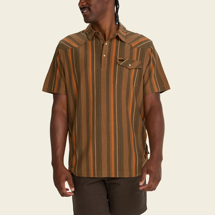 Man wearing a brown and orange striped shirt on a beige background