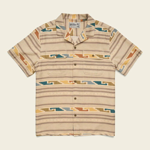 Beige patterned shirt with a brand logo on a light beige background