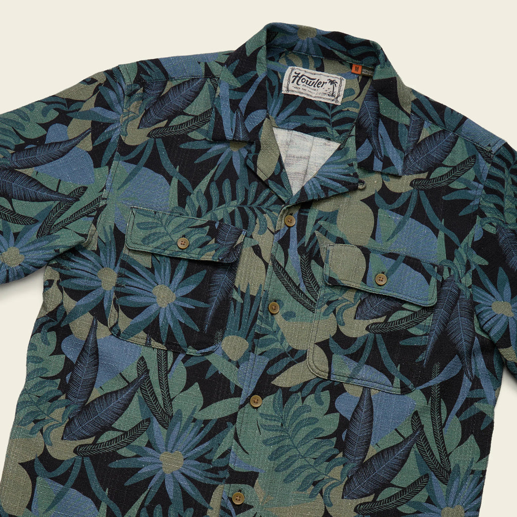 Floral patterned shirt with a brand label on a light background