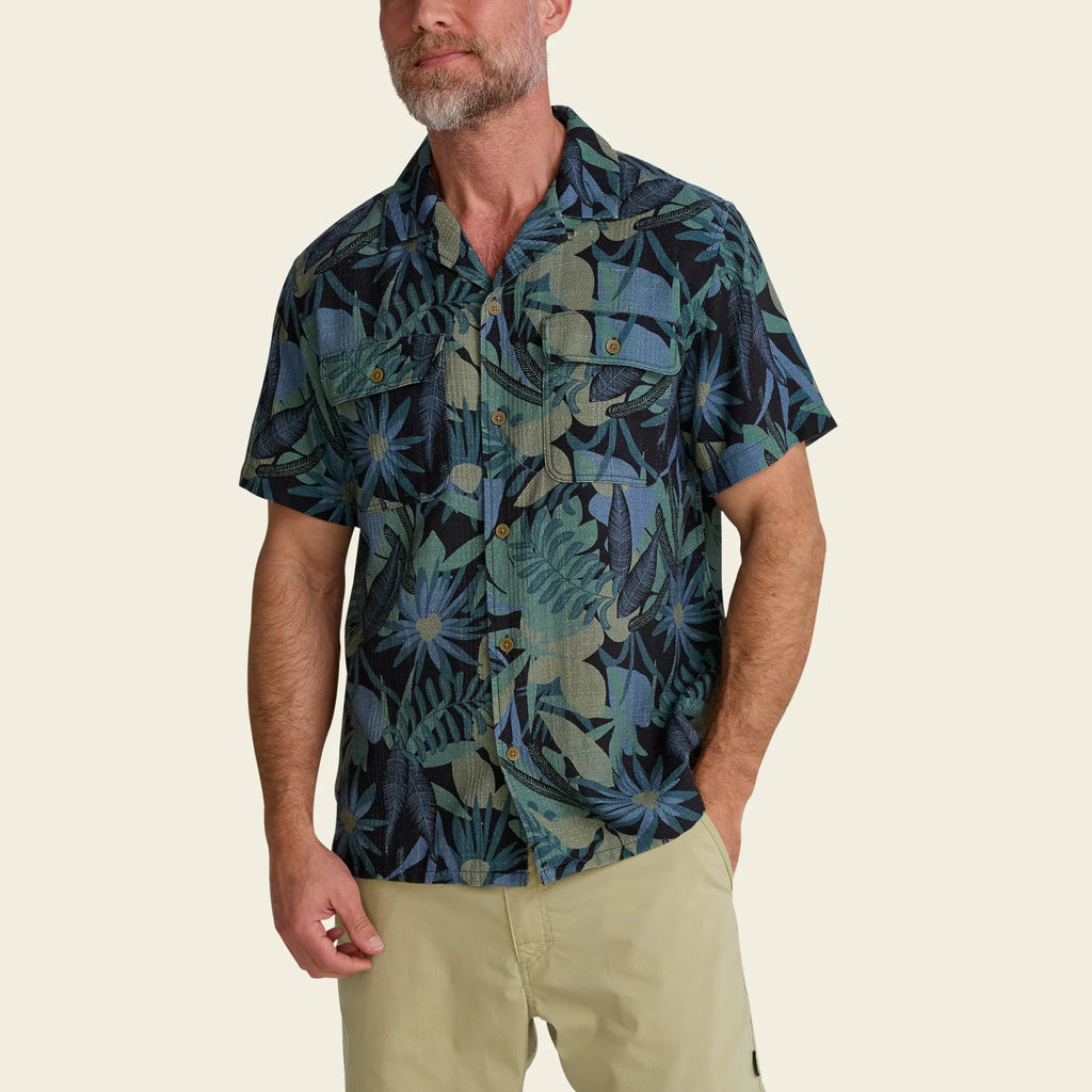 Man wearing a patterned shirt with a beige background