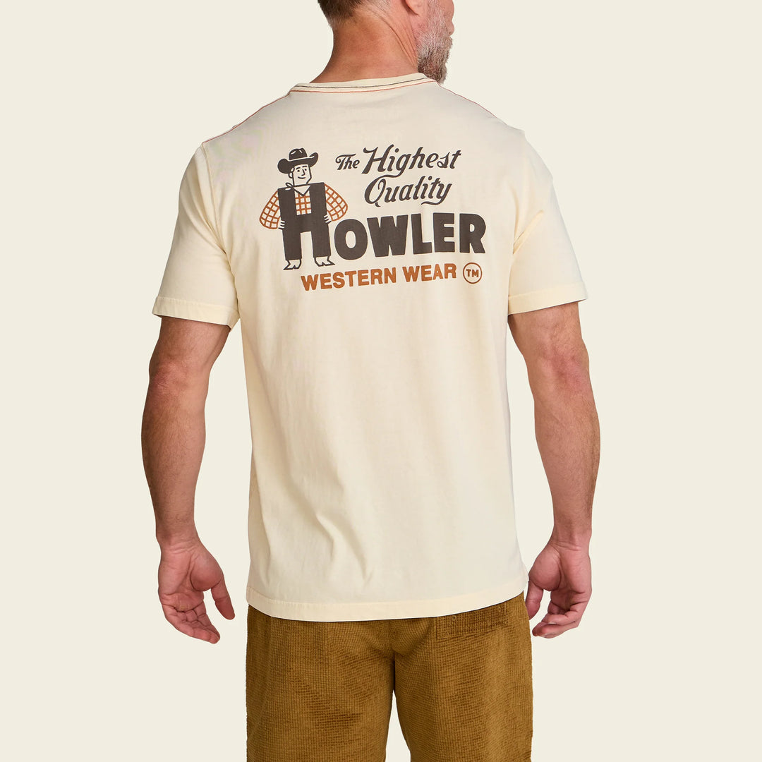 Man wearing a cream-colored t-shirt with 'Howler Western Wear' logo on a beige background