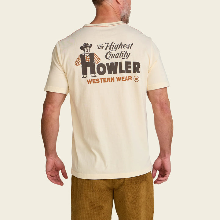 Man wearing a cream-colored t-shirt with 'Howler Western Wear' logo on a beige background