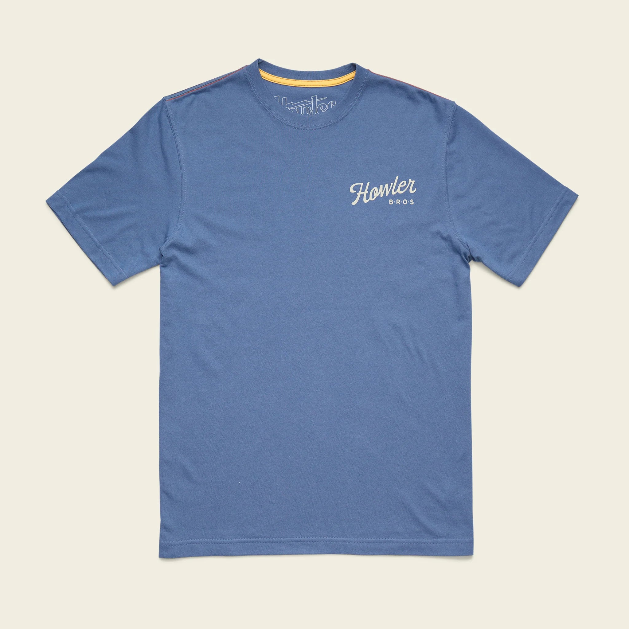 Blue t-shirt with 'Howler Bros' logo on a beige background