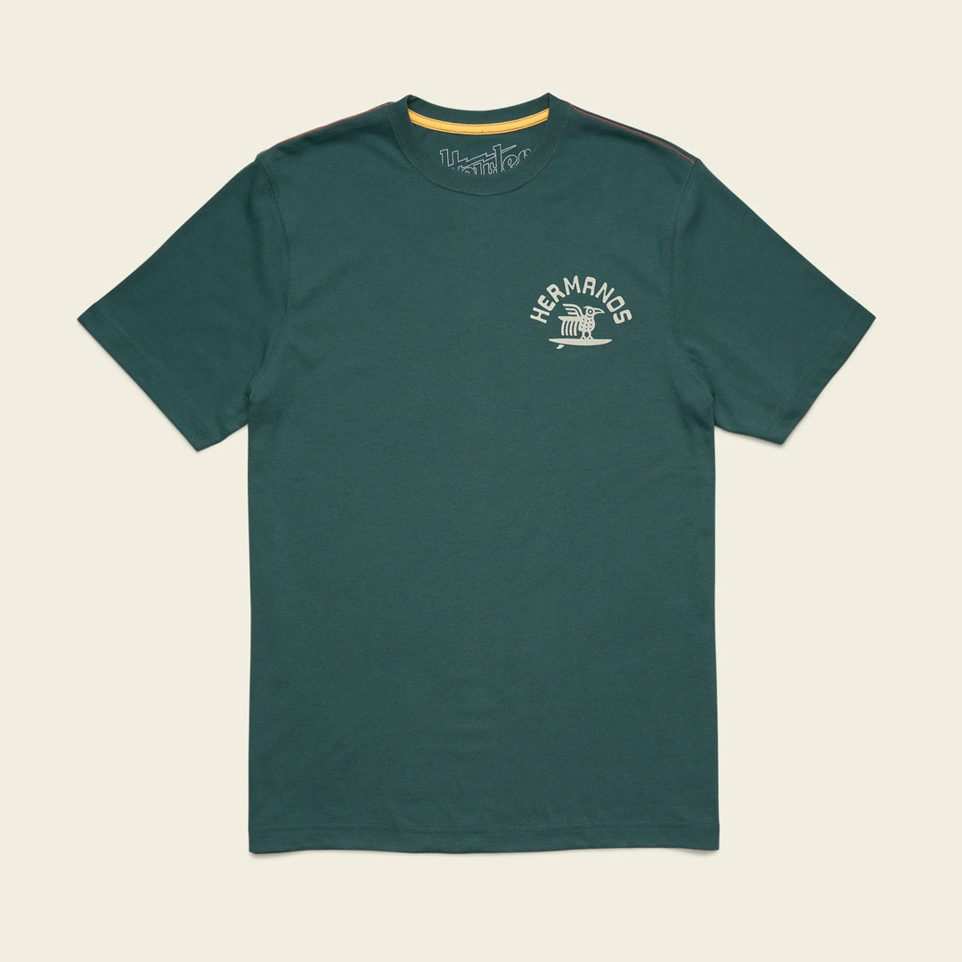 Green t-shirt with a logo on a beige background