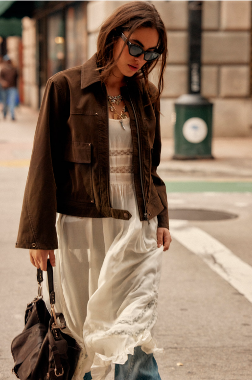 Blair Vegan Suede Sierra Jacket in Chocolate Torte on model wearing an ivory dress and walking down the street