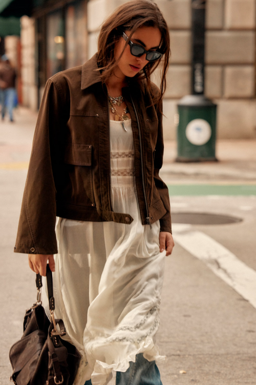 Blair Vegan Suede Sierra Jacket in Chocolate Torte on model wearing an ivory dress and walking down the street