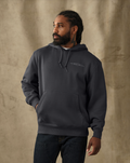 male model wearing a filson black hoodie in a studio