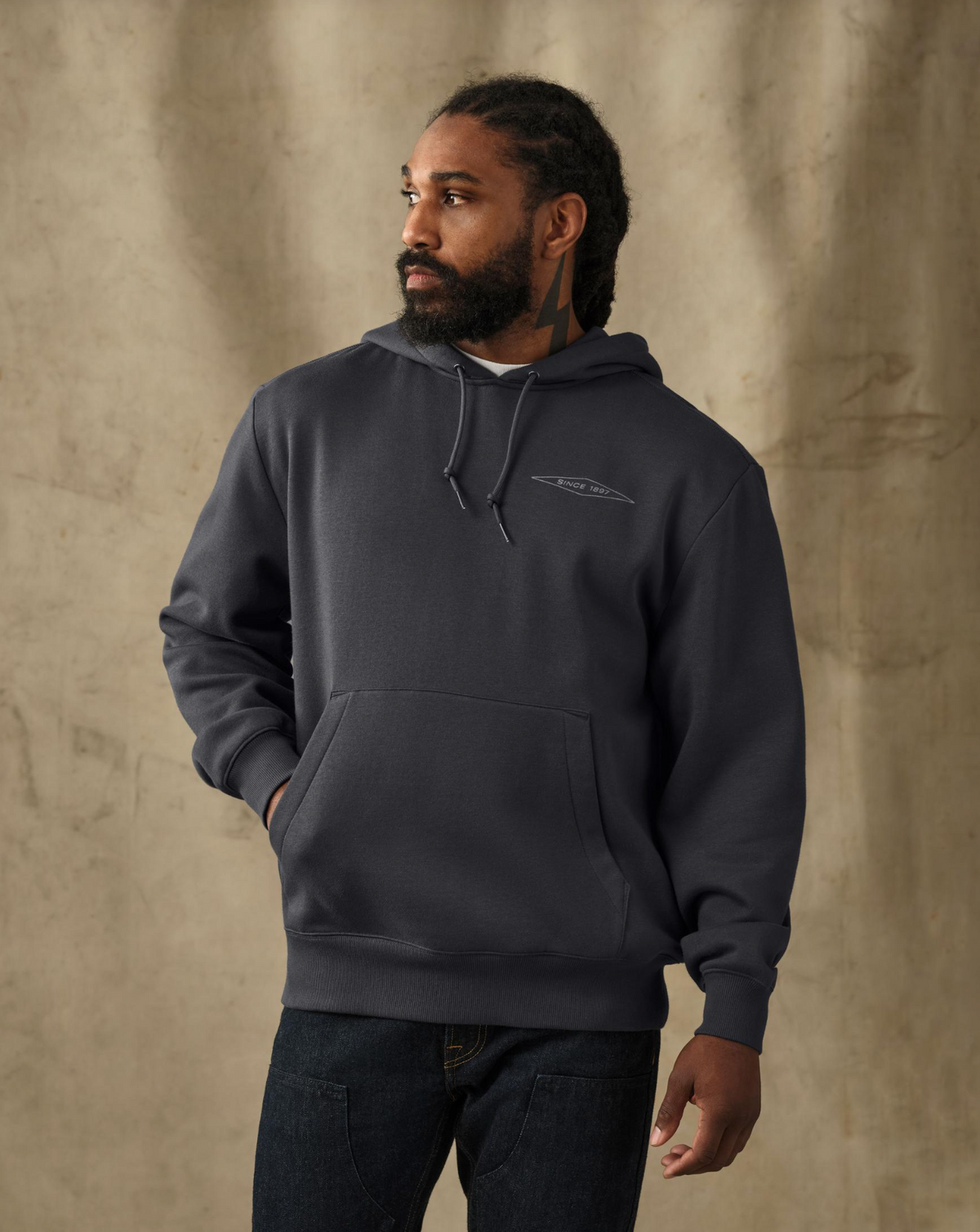 male model wearing a filson black hoodie in a studio