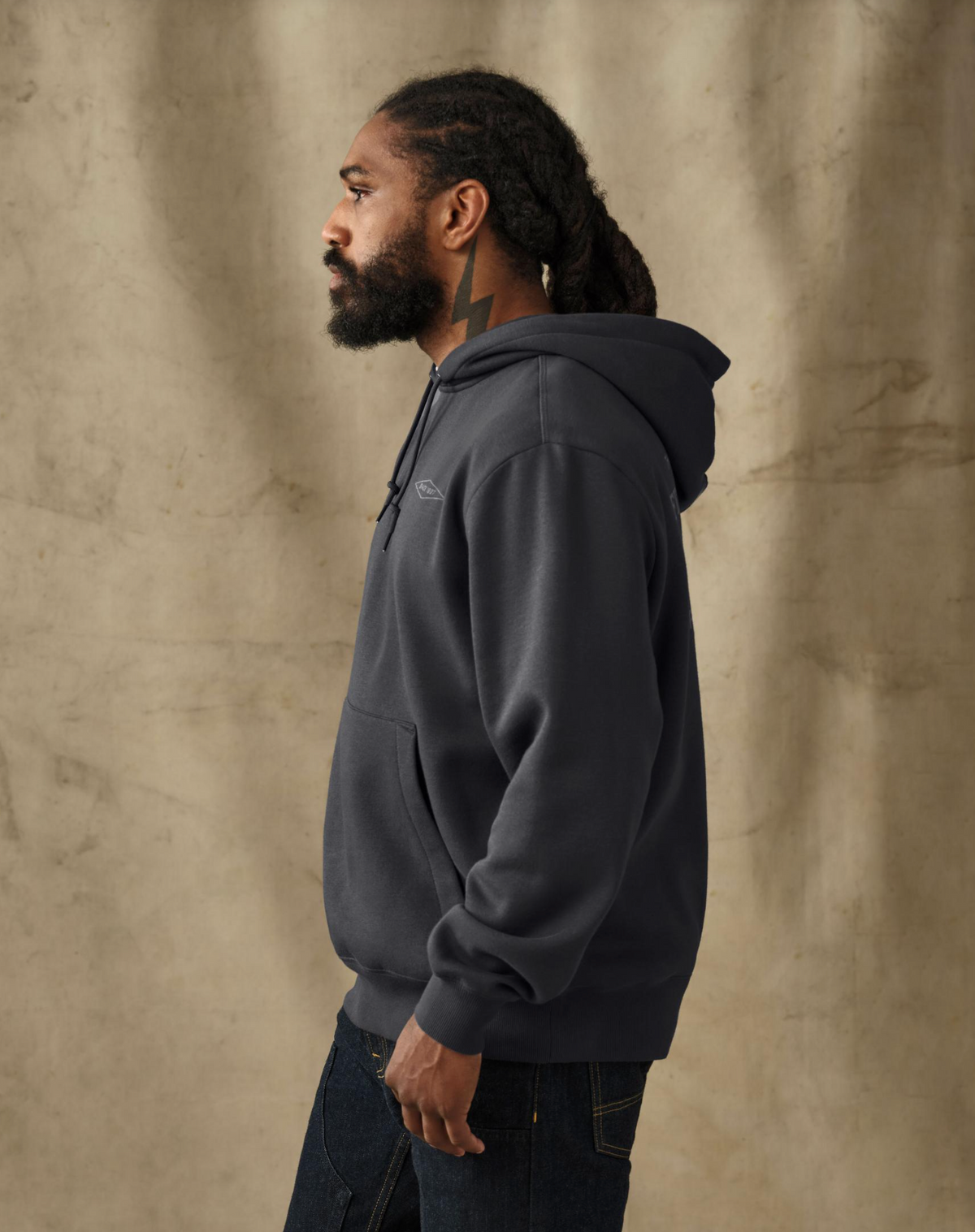 male model wearing a filson black hoodie in a studio