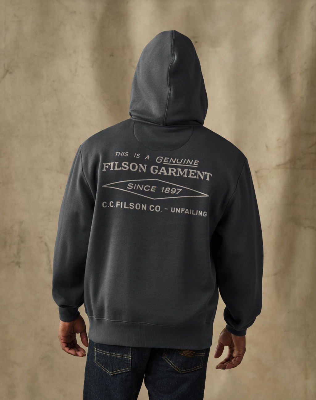 male model wearing a filson black hoodie in a studio