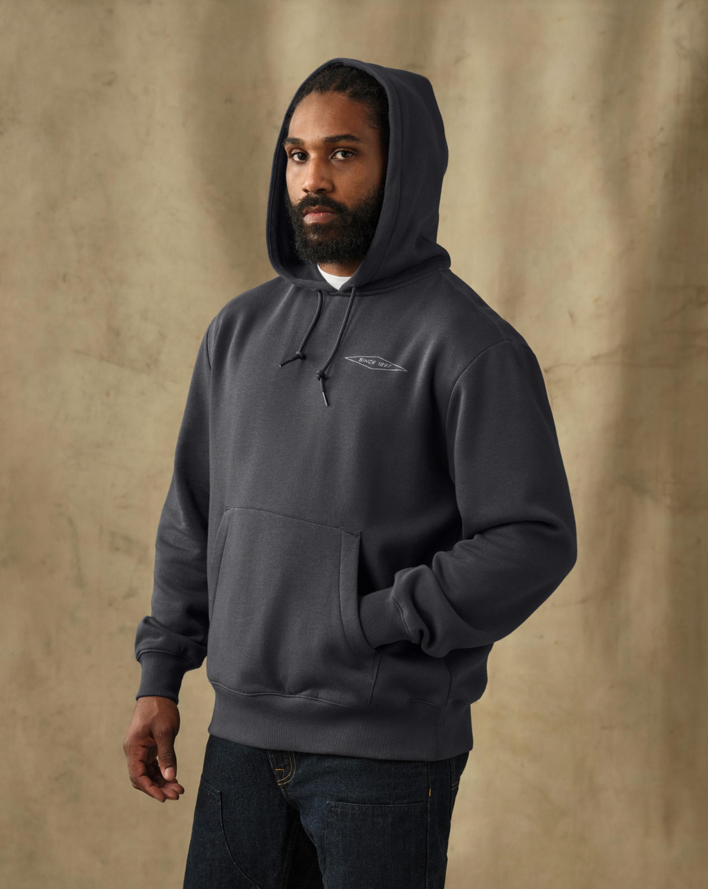 male model wearing a filson black hoodie in a studio