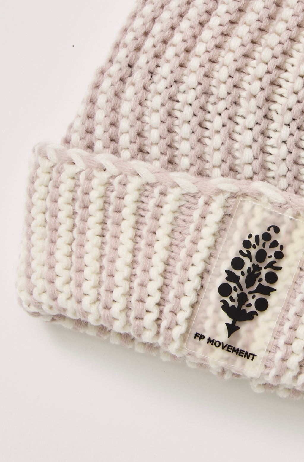 A light beige and white ribbed knit beanie hat featuring a black embroidered tree logo on the front cuff with the text 'THE TREESCHOOL' underneath.