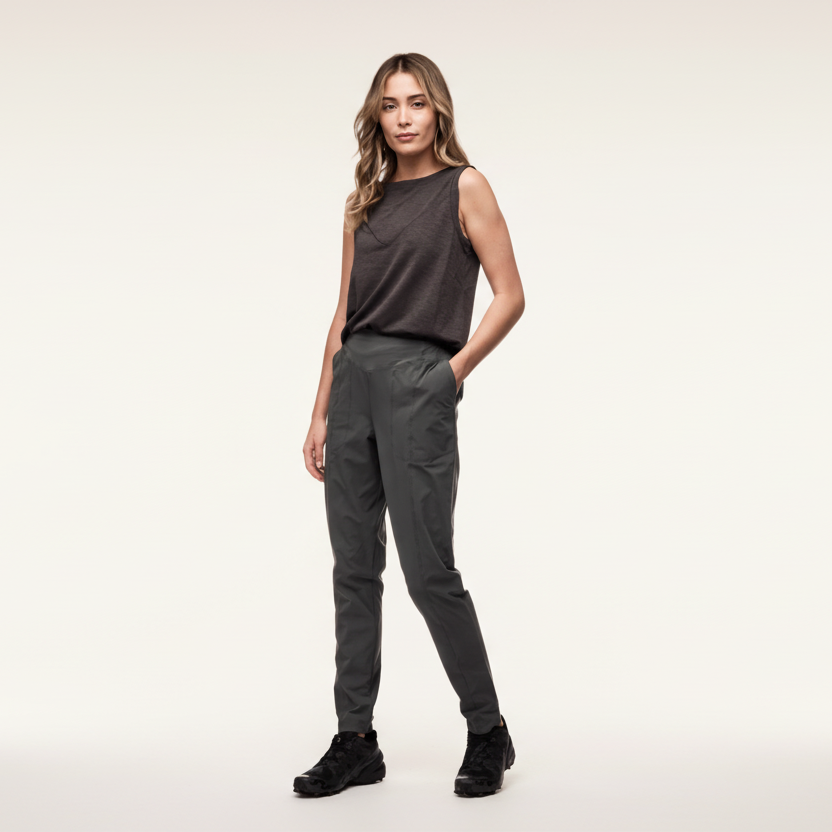 Woman wearing a sleeveless top and pants on a white background