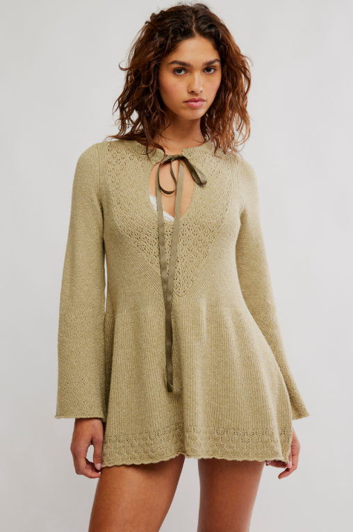 Woman modeling knit sweater dress, white background