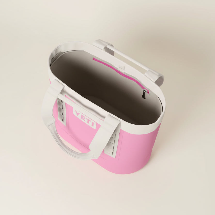 Pink and white cooler bag with 'YETI' branding on a transparent background