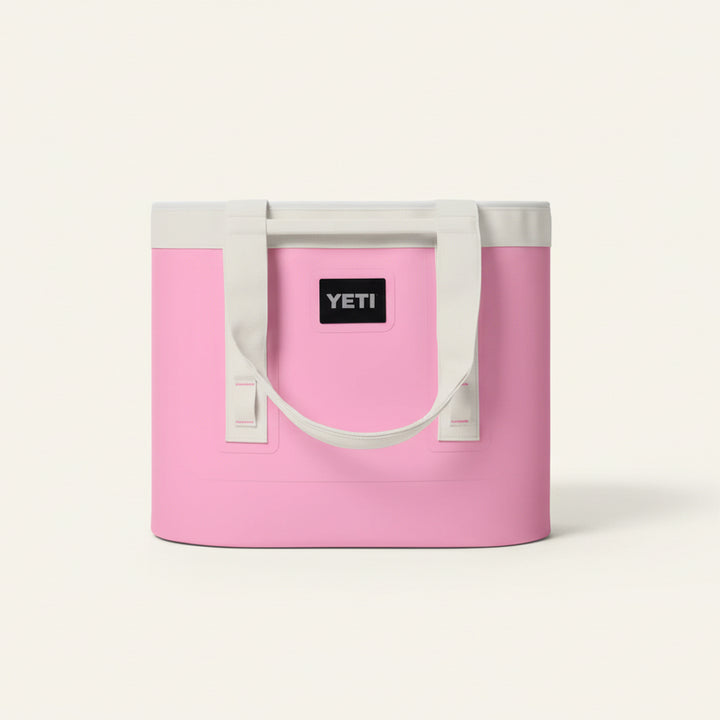 Pink cooler bag with white handles featuring the YETI logo on a white background