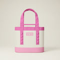Pink and white YETI tote bag on a black background