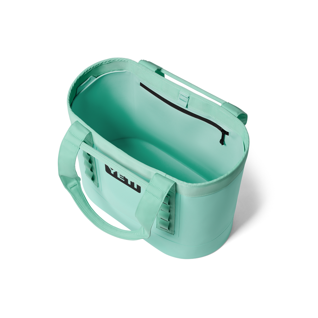 Mint green container with a handle on a white background