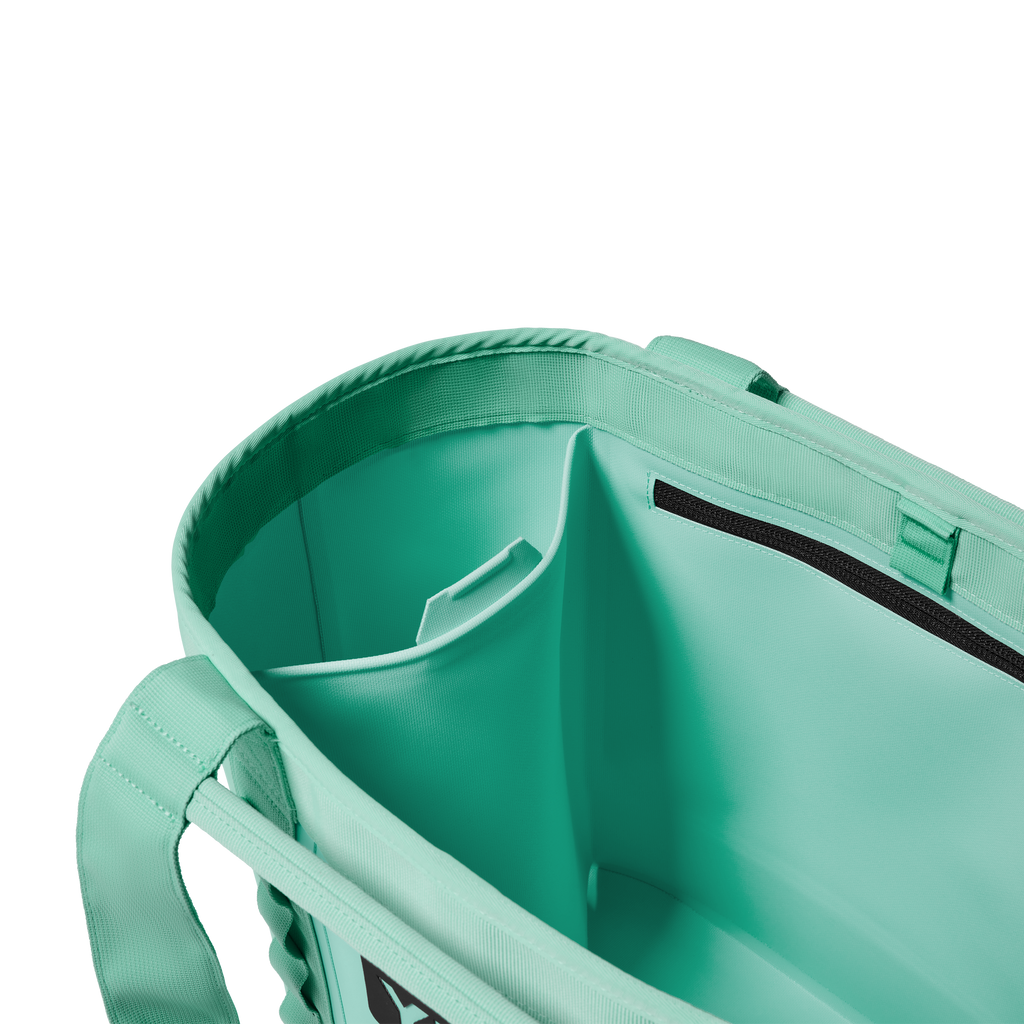 Close-up of a teal bag with a handle on a white background