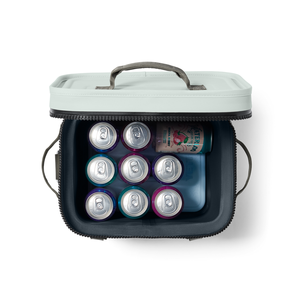 Portable cooler with cans of 7UP on a white background
