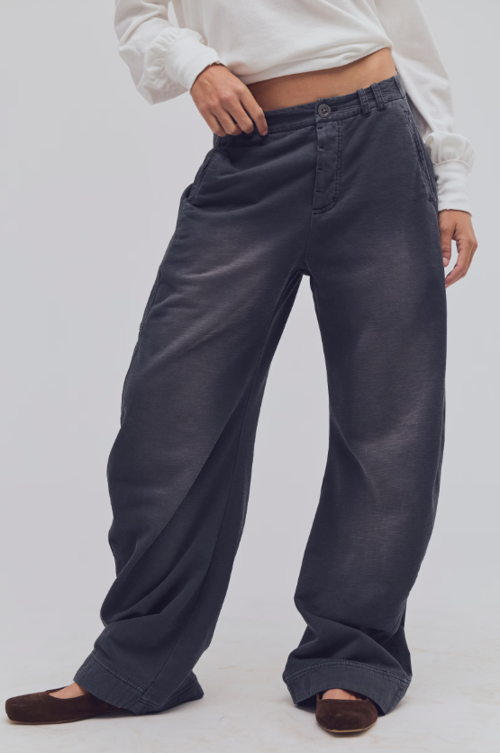 Woman wearing black wide leg pants brown shoes and long sleeve white T-sirt