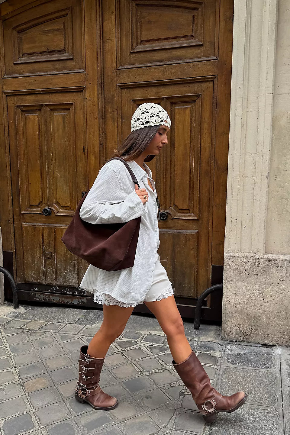 Suzie Suede Slouch Tote in Espresso on shoulder of model walking down a street