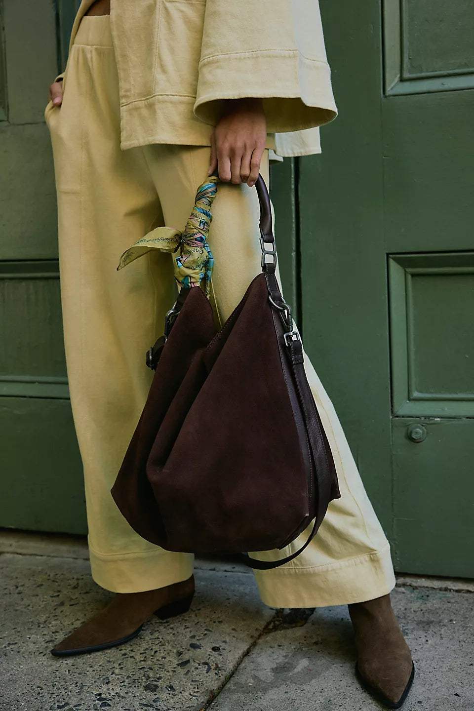 Suzie Suede Slouch Tote in Espresso held by a model 