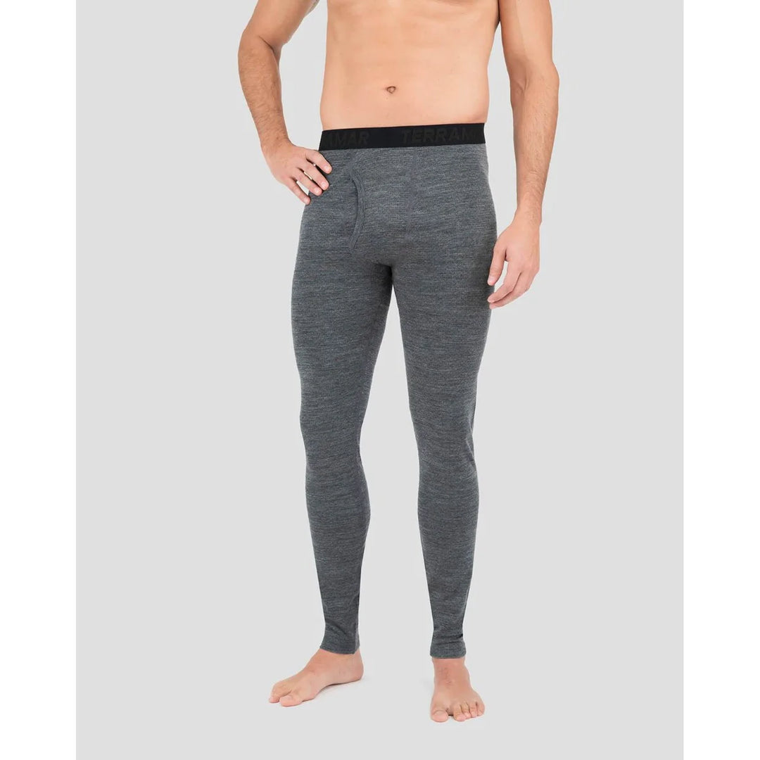 Person wearing gray thermal leggings on a plain background