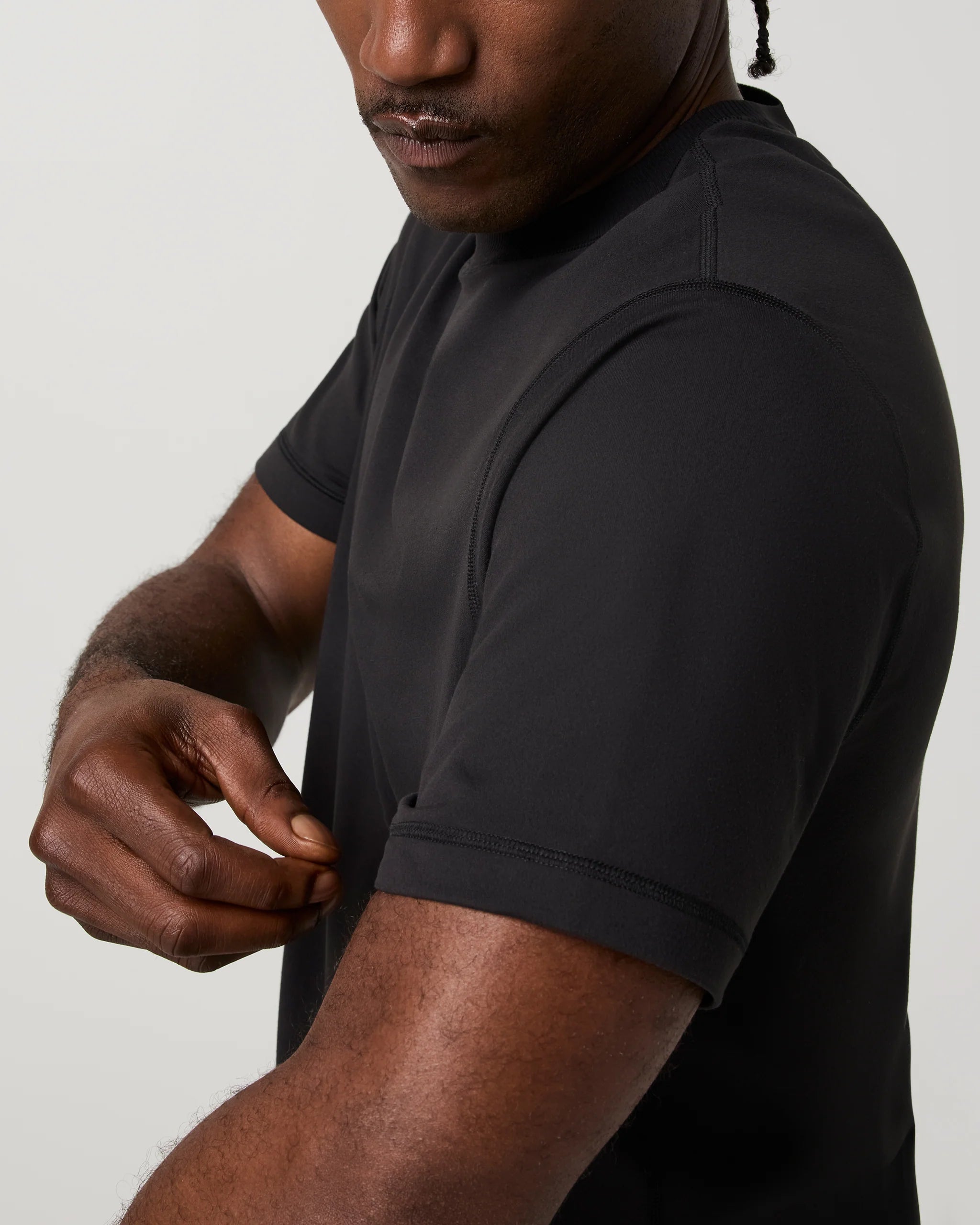 Man wearing a black t-shirt against a plain background