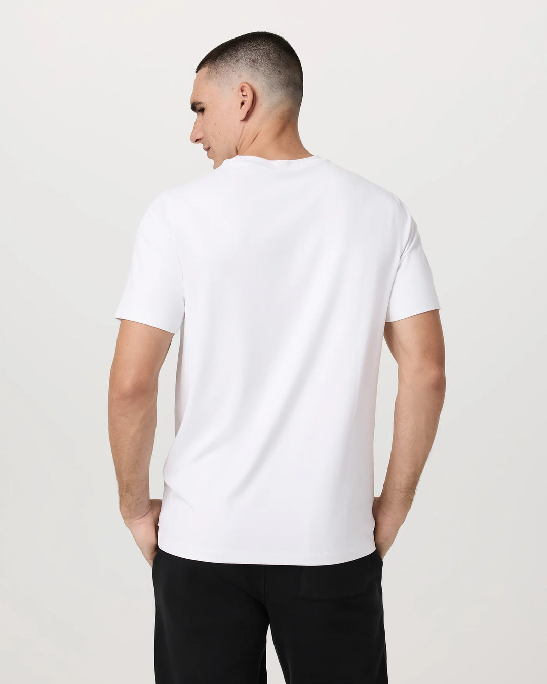 Man wearing a white t-shirt against a plain background