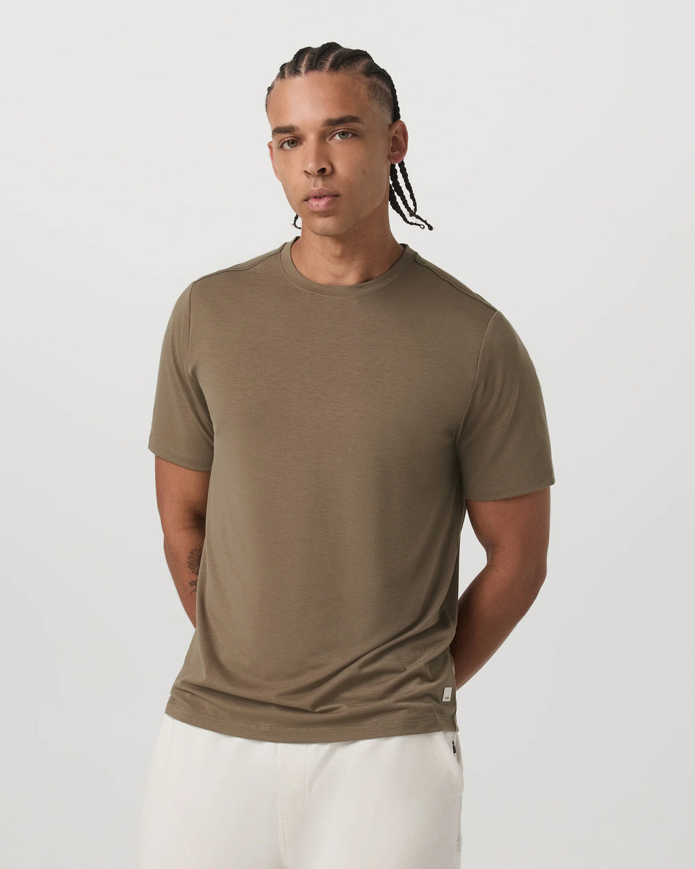 Man wearing a brown t-shirt against a white background