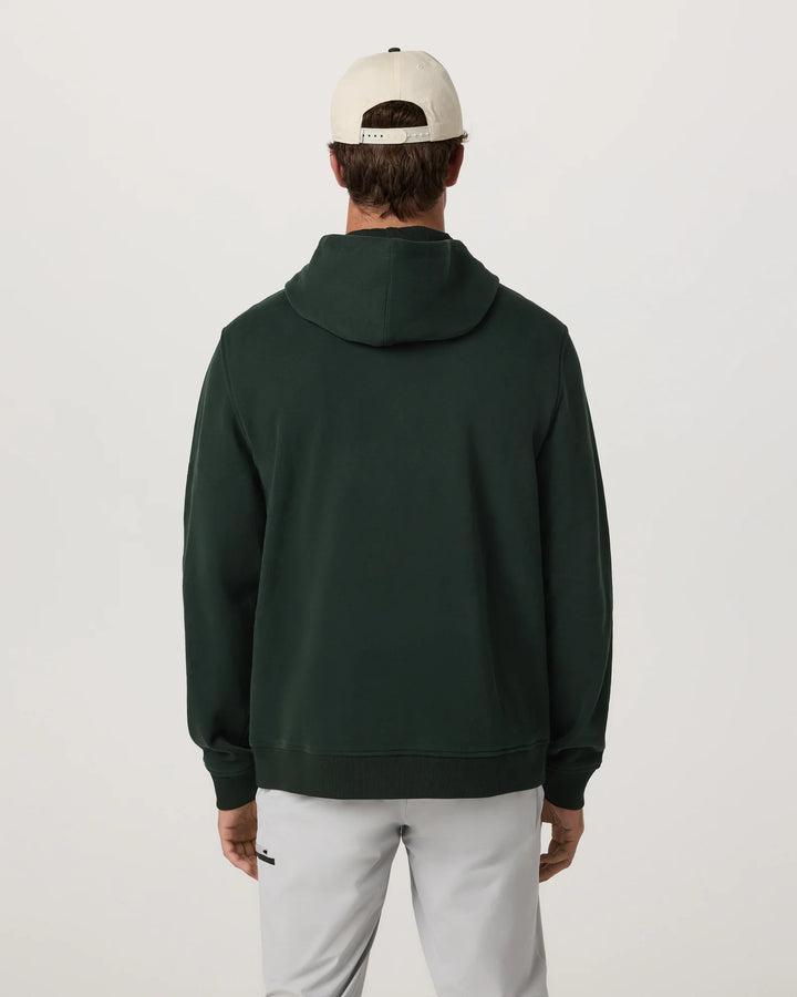 Person wearing a dark green hoodie and light gray pants on a white background
