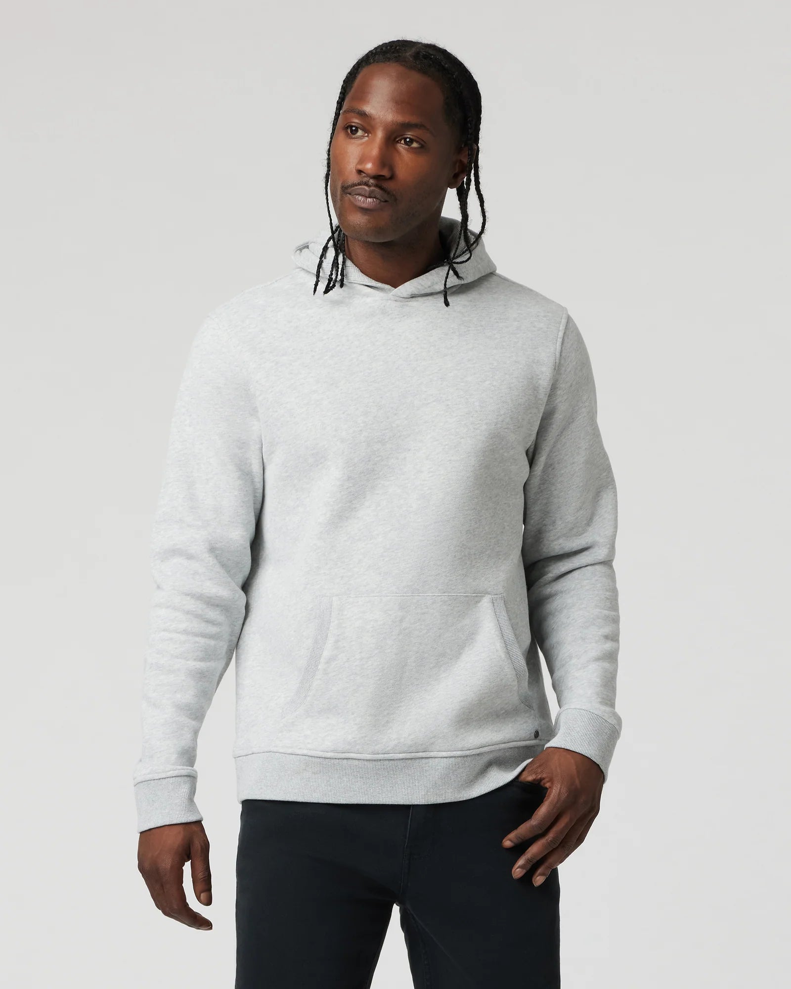 Man wearing a gray hoodie against a plain background