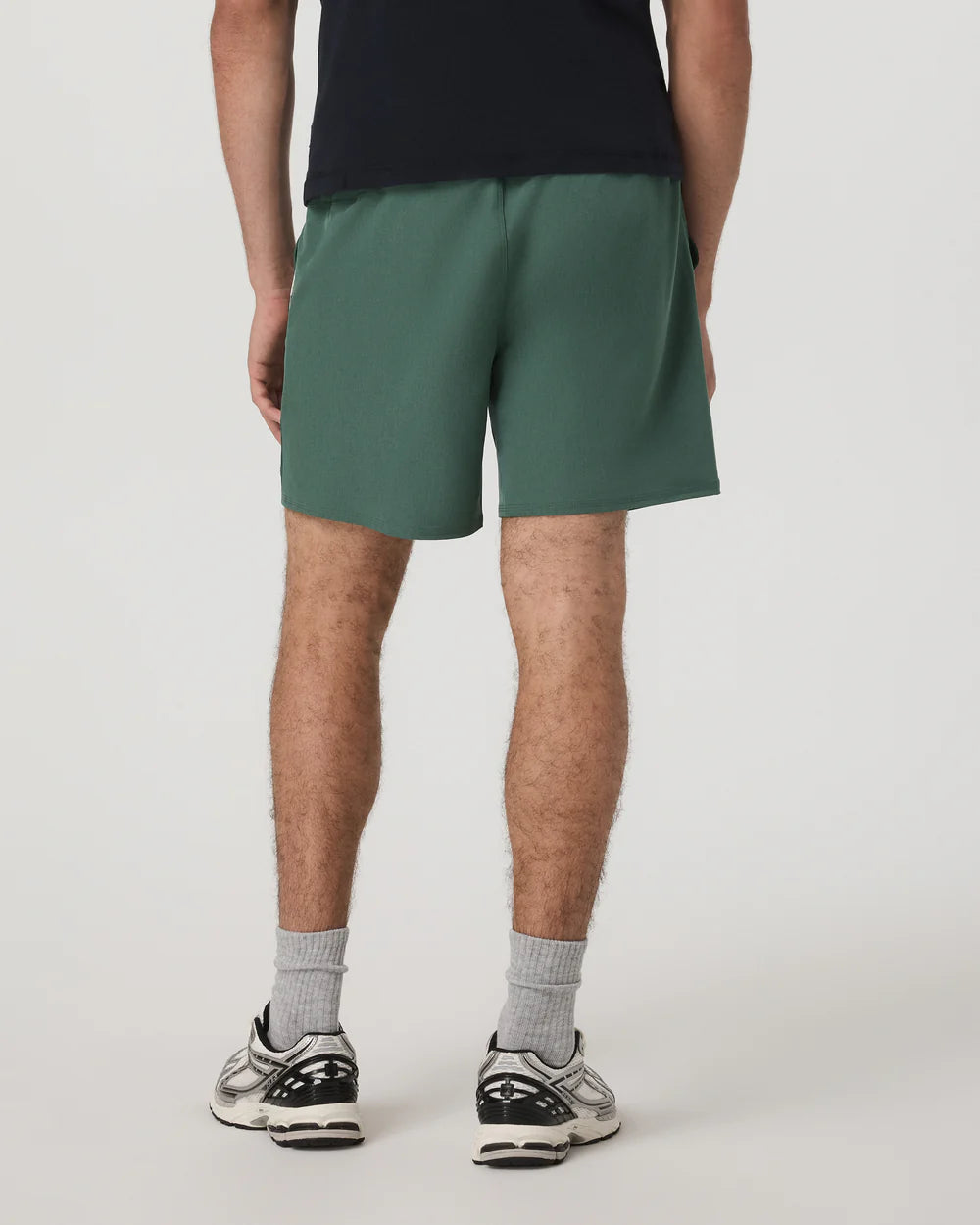 Person wearing green shorts on a plain background