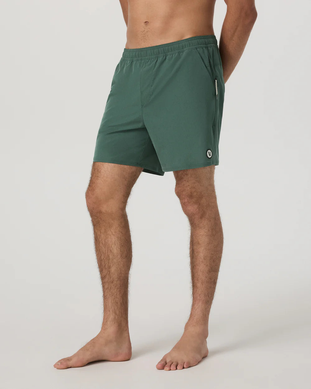 Person wearing green shorts on a plain background