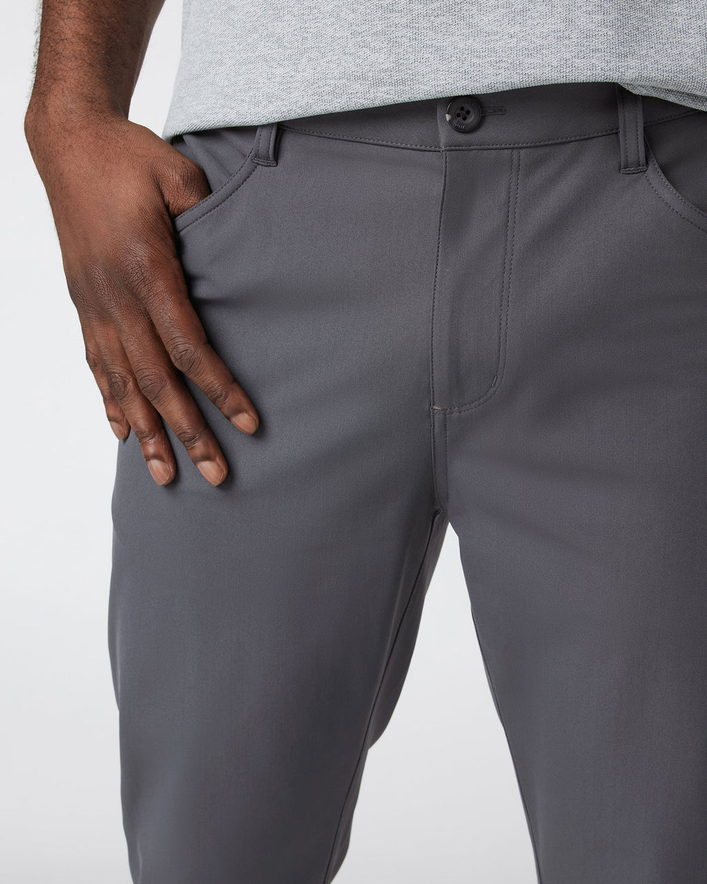 Gray pants worn by a person on a white background