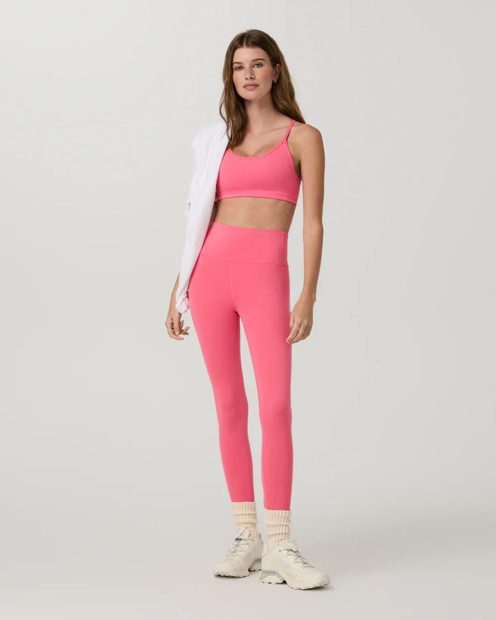 Woman wearing a pink athletic outfit on a white background