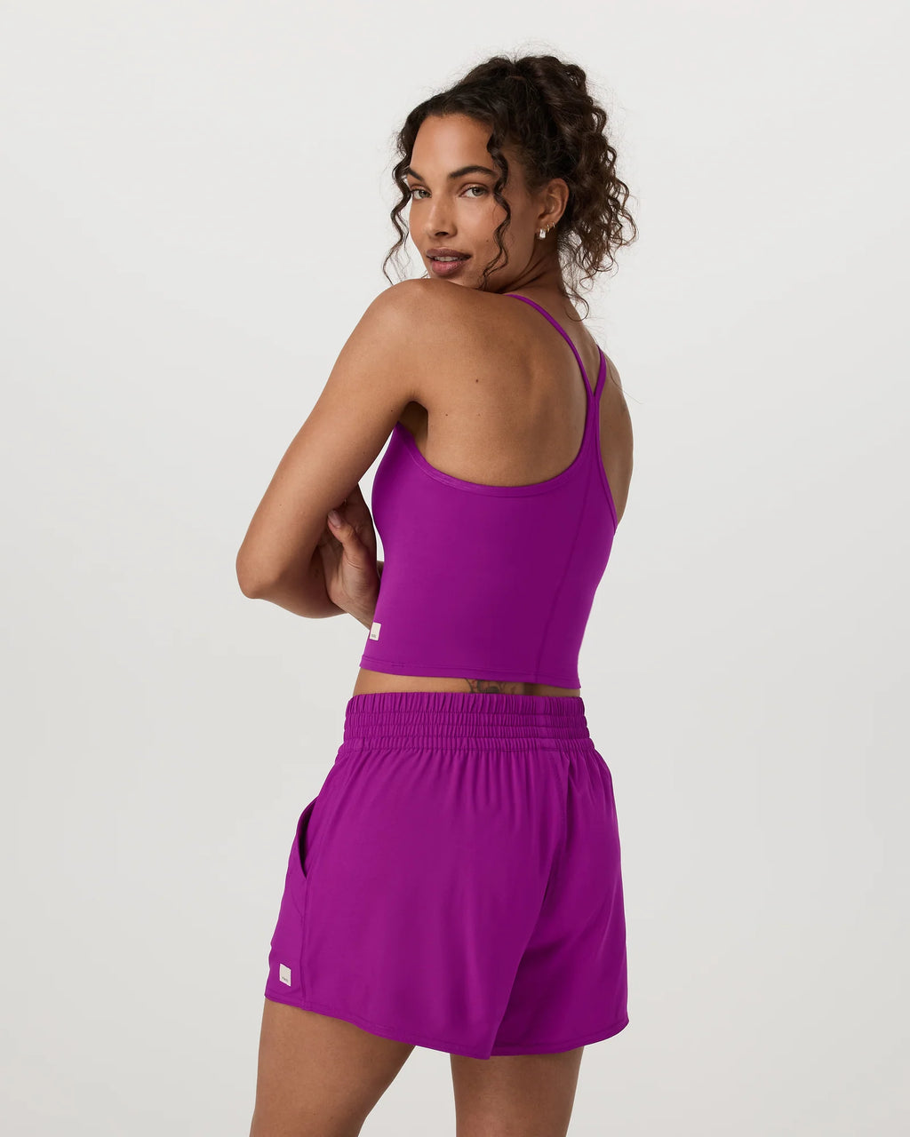 Woman wearing a purple athletic outfit on a white background