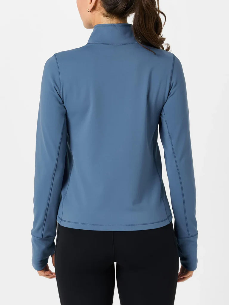 Blue long-sleeve athletic top worn by a person on a white background