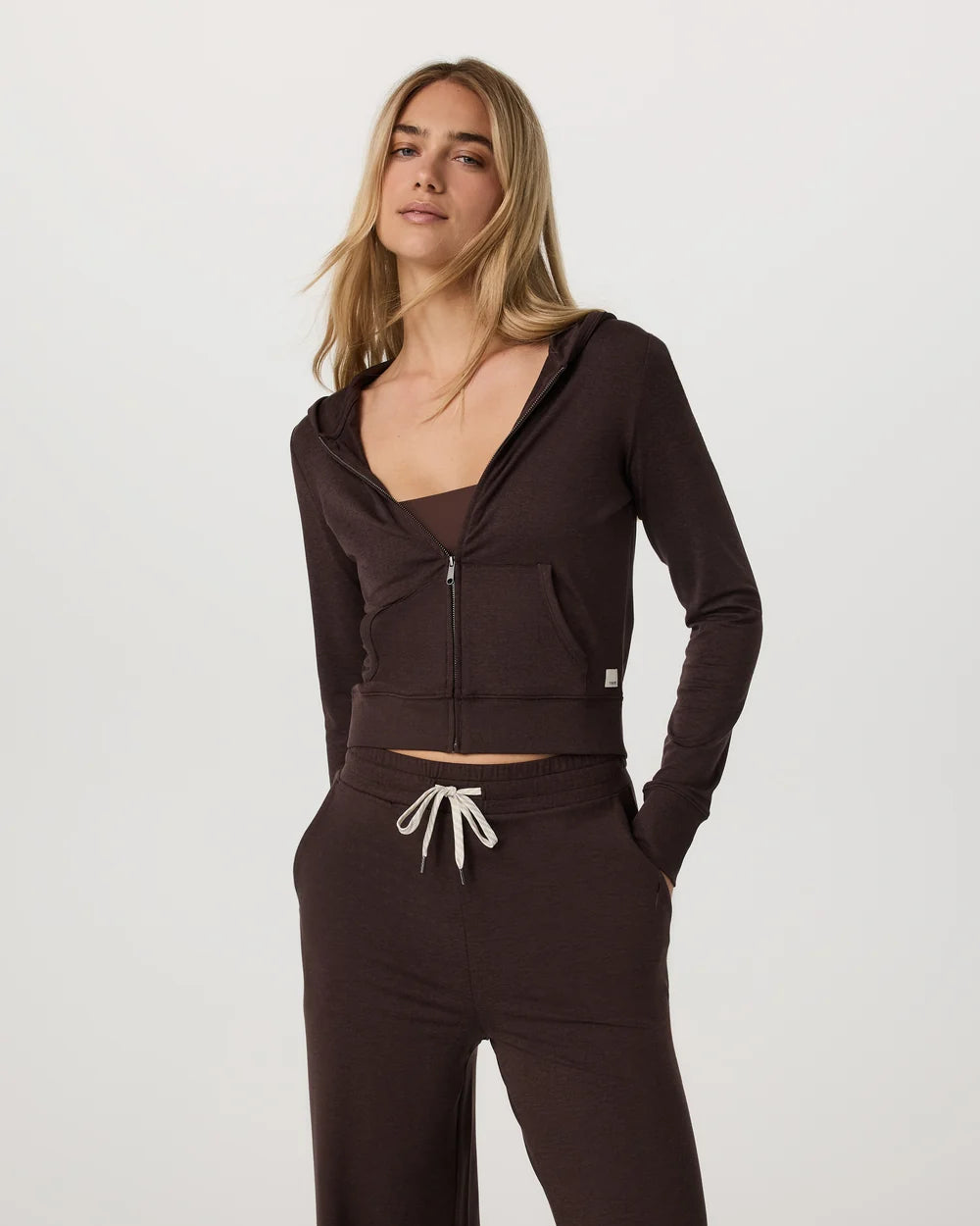 Woman wearing a brown tracksuit on a white background