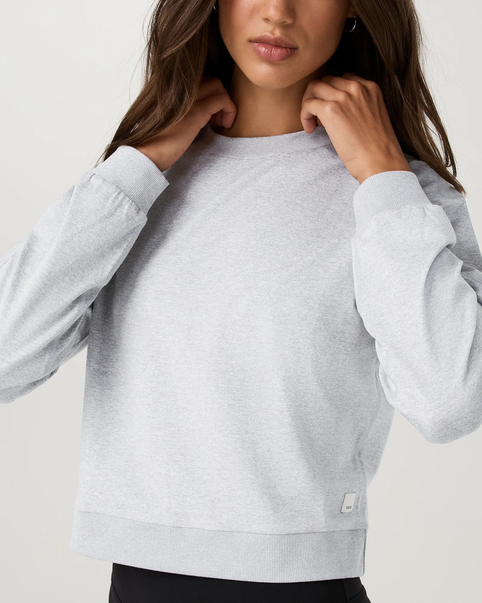 Gray sweatshirt worn by a person on a plain background