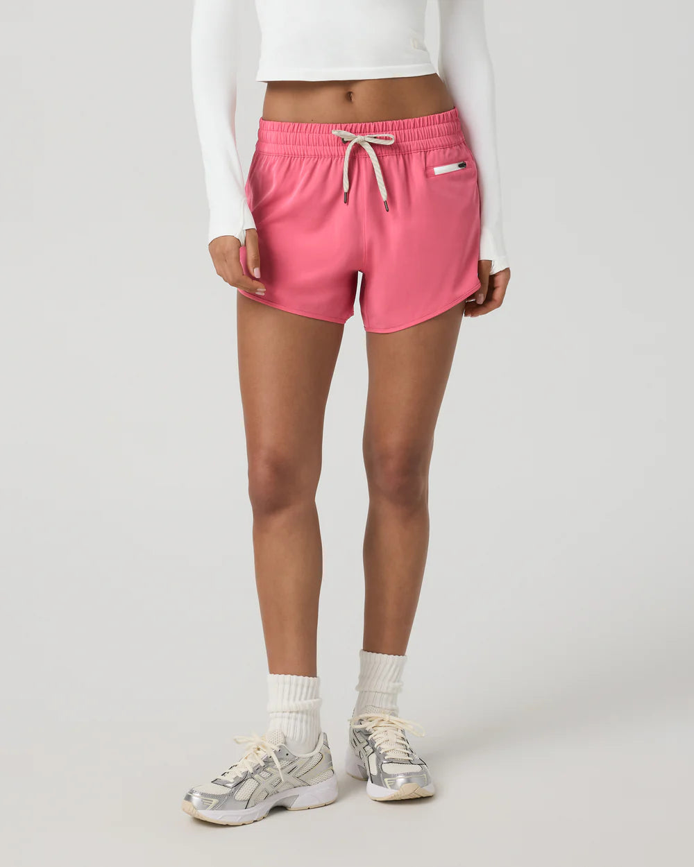 Person wearing pink shorts on a white background